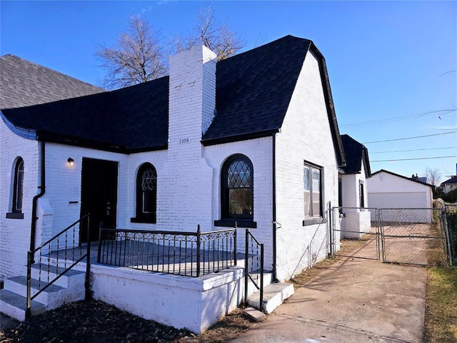 view of front of property featuring a garage and an outbuilding