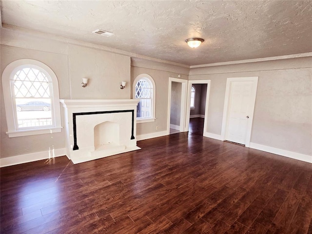 unfurnished living room with a textured ceiling, dark hardwood / wood-style floors, and crown molding