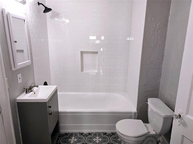 full bathroom featuring tile patterned flooring, vanity, tiled shower / bath combo, and toilet