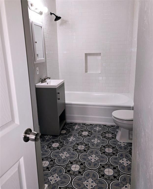 full bathroom with tile patterned floors, vanity, toilet, and tiled shower / bath combo