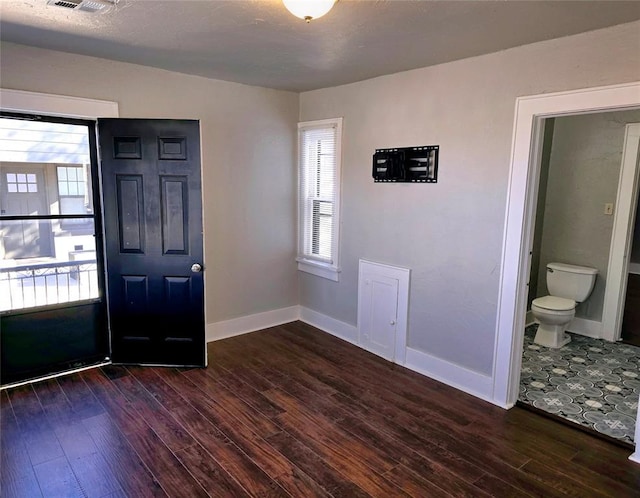 entrance foyer with a healthy amount of sunlight and dark hardwood / wood-style flooring