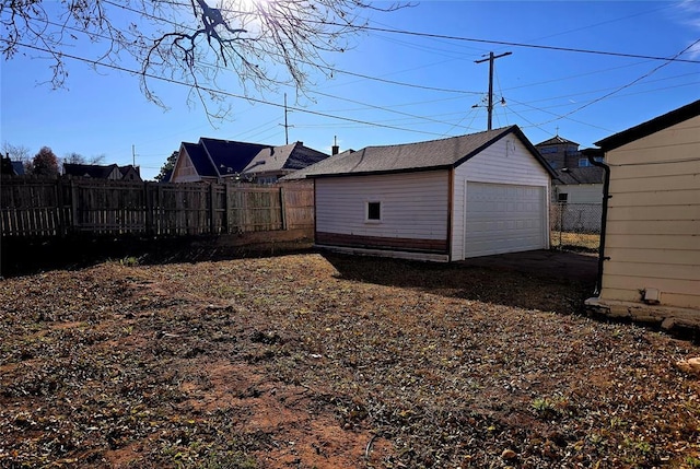 view of yard featuring a garage and an outbuilding