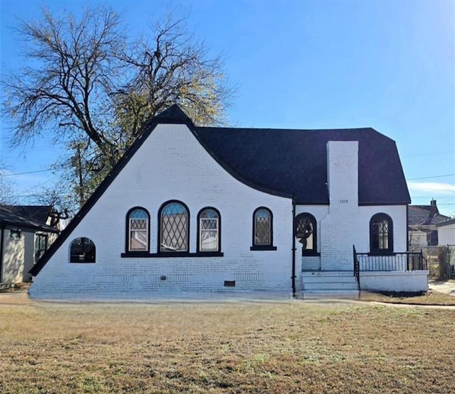 1108 NE 16th St, Oklahoma City, OK 73117 - view of front of property with brick siding, crawl space, a front yard, and a chimney