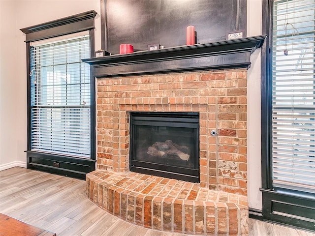 room details featuring hardwood / wood-style floors and a brick fireplace