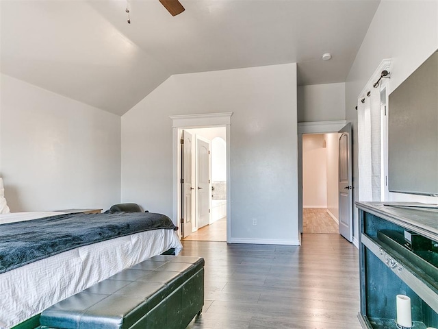 bedroom with ceiling fan, hardwood / wood-style floors, and lofted ceiling