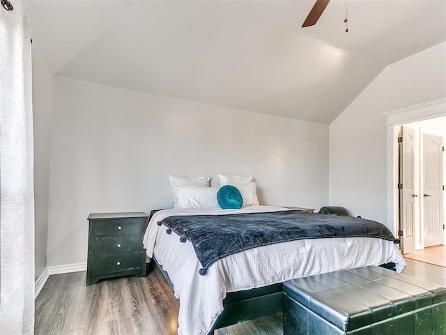 bedroom featuring ceiling fan, dark hardwood / wood-style floors, and lofted ceiling