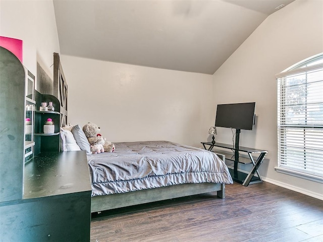 bedroom with vaulted ceiling and dark wood-type flooring