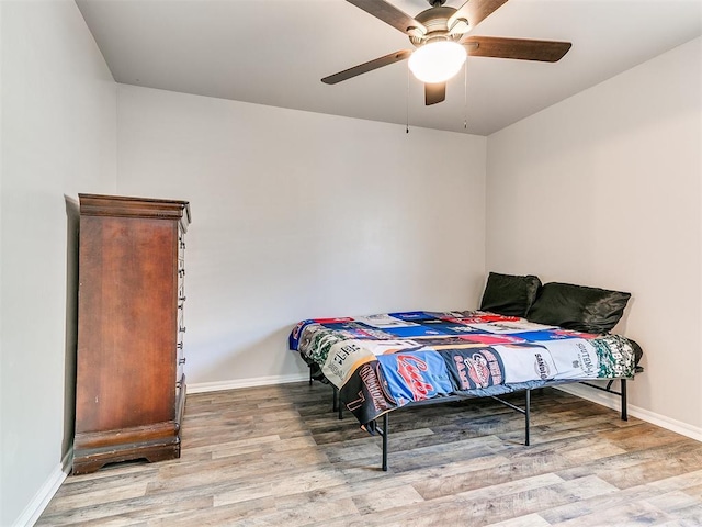 bedroom with ceiling fan and light hardwood / wood-style flooring