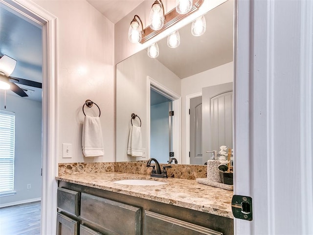 bathroom featuring vanity, ceiling fan, and wood-type flooring