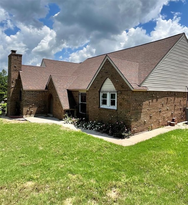 15268 Pheasant Run, Choctaw, OK 73020 - view of front of property featuring a chimney, a front lawn, and brick siding