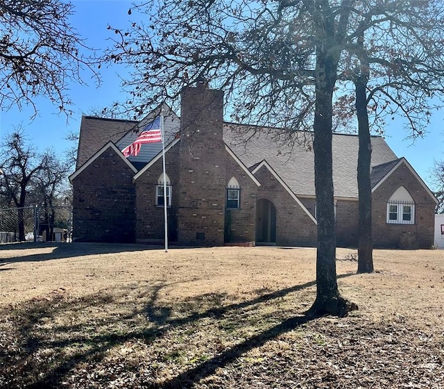 15268 Pheasant Run, Choctaw, OK 73020 - view of front of home with brick siding, a chimney, and roof with shingles