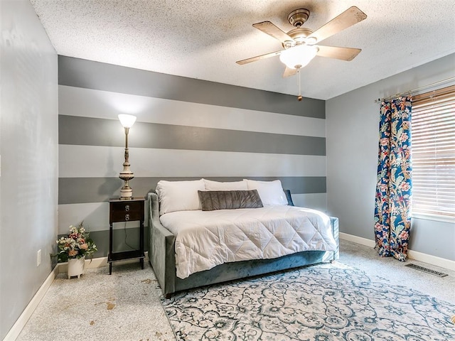 carpeted bedroom featuring a textured ceiling and ceiling fan