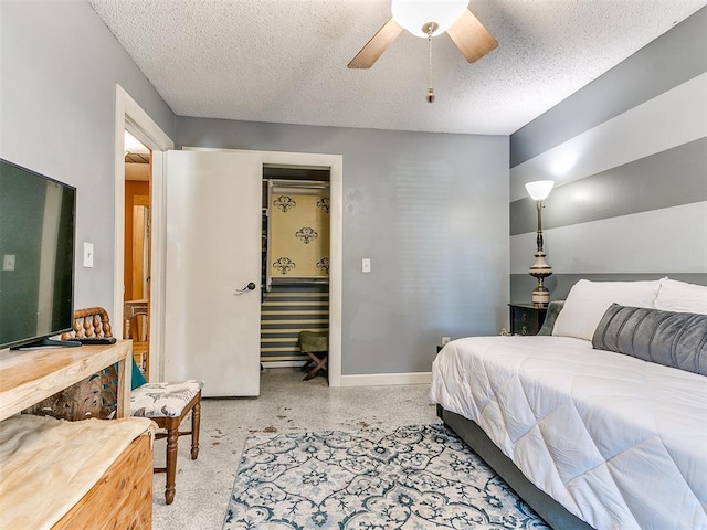 bedroom with a textured ceiling and ceiling fan