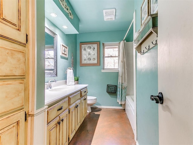 full bathroom featuring vanity, toilet, shower / bath combo with shower curtain, and concrete floors