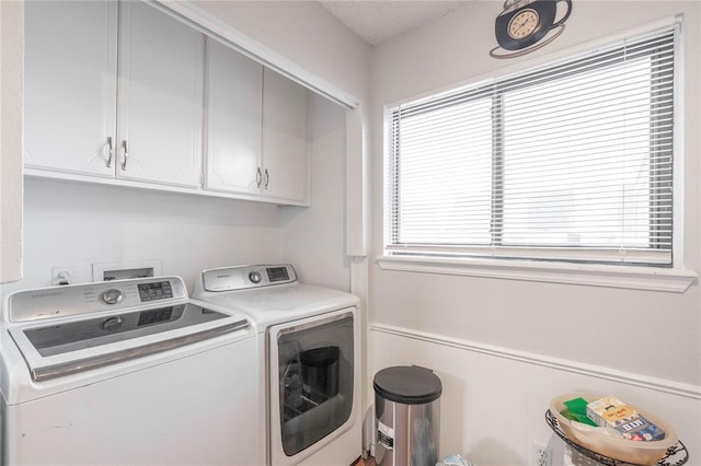 laundry area featuring cabinets, independent washer and dryer, and a wealth of natural light