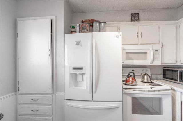 kitchen featuring white cabinets, white appliances, and a textured ceiling