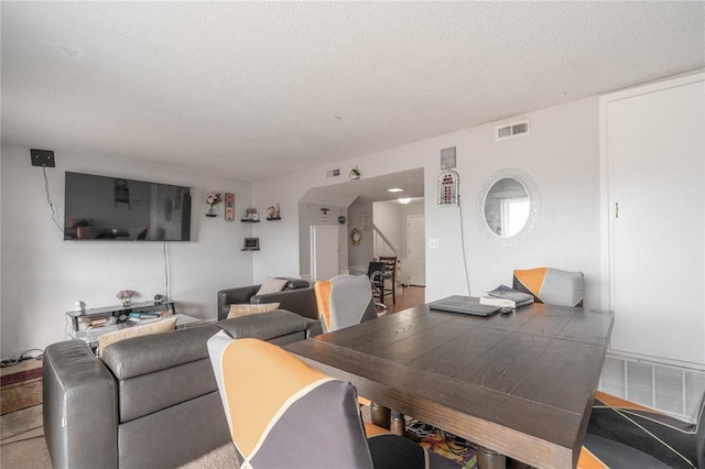 dining area featuring a textured ceiling