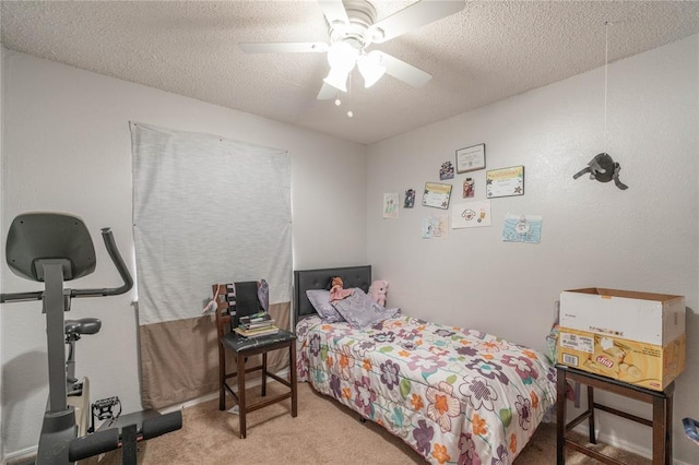 carpeted bedroom with ceiling fan and a textured ceiling