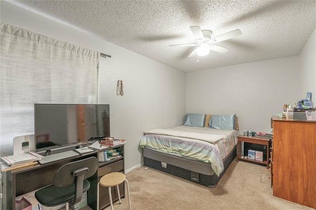 bedroom with a textured ceiling, ceiling fan, and light carpet