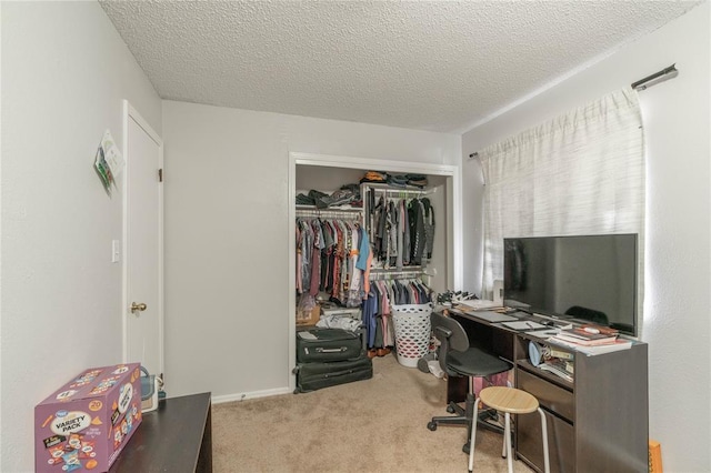 office area featuring light colored carpet and a textured ceiling