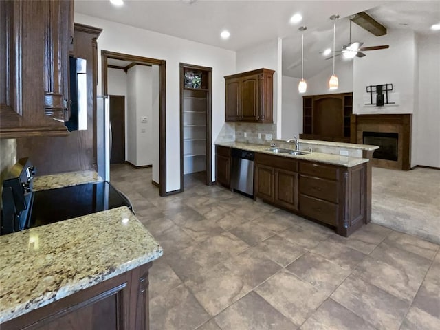 kitchen with pendant lighting, lofted ceiling with beams, appliances with stainless steel finishes, dark brown cabinets, and a tiled fireplace