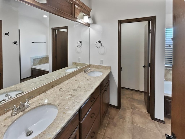 bathroom featuring a washtub, vanity, and tile patterned flooring