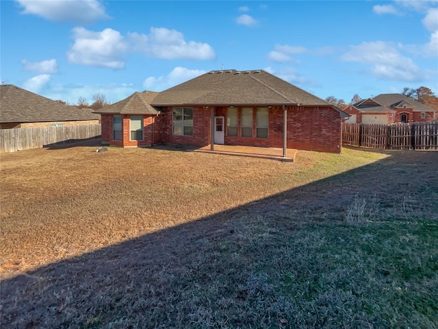 rear view of house with a yard