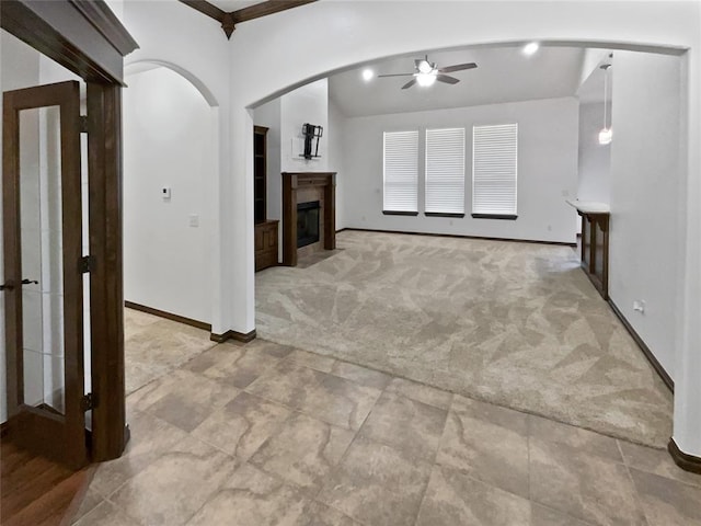 unfurnished living room with ceiling fan, light carpet, and ornamental molding