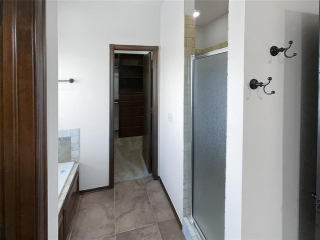 bathroom with tile patterned flooring and separate shower and tub