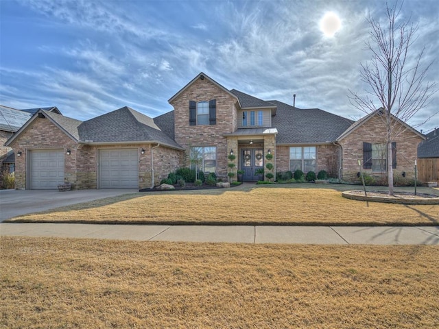 view of front of house with a garage and a front lawn