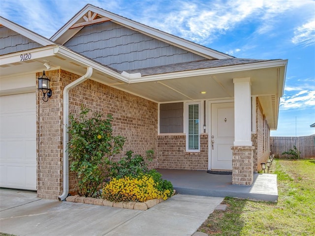 property entrance with a porch and a garage