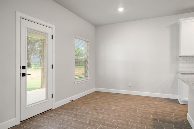 unfurnished dining area featuring light hardwood / wood-style flooring