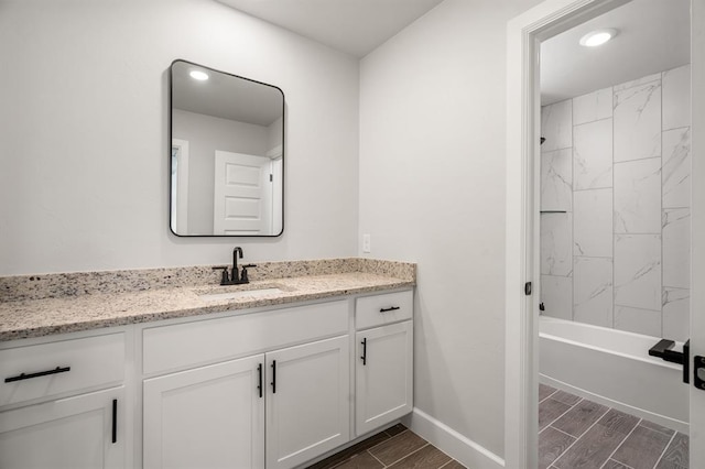 bathroom with vanity and tiled shower / bath