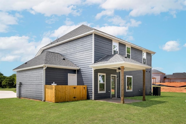 view of front of house with a front yard and a patio area