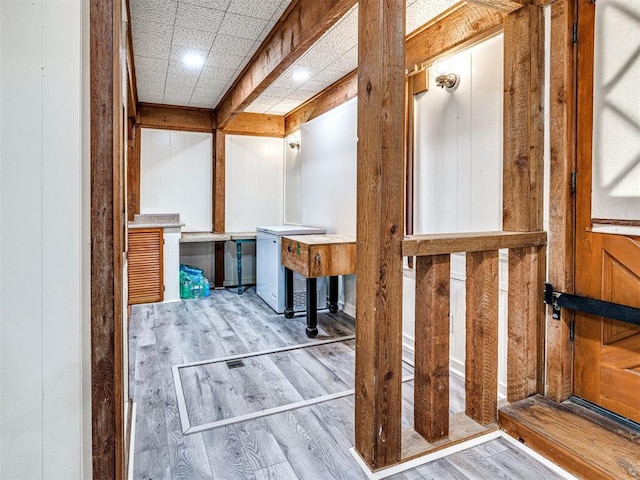 bathroom with wooden walls and wood-type flooring