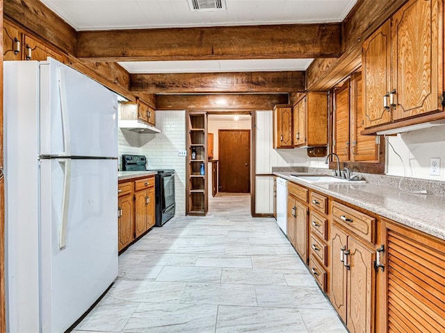 kitchen featuring beam ceiling, white appliances, and sink