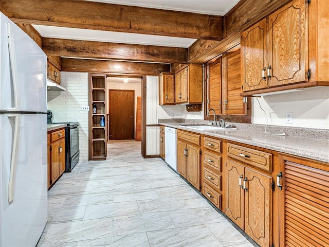 kitchen with beamed ceiling, white appliances, and sink