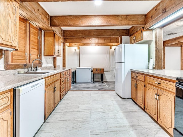 kitchen with beam ceiling, white appliances, and sink