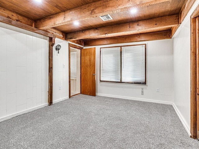 empty room featuring beamed ceiling, wooden ceiling, and carpet floors