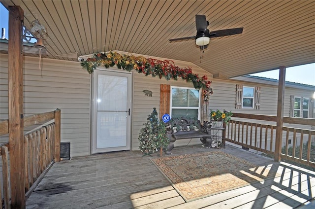 wooden deck featuring ceiling fan