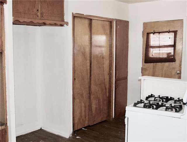 kitchen with dark hardwood / wood-style flooring and white range with gas stovetop