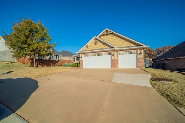 craftsman house featuring a garage and a front lawn