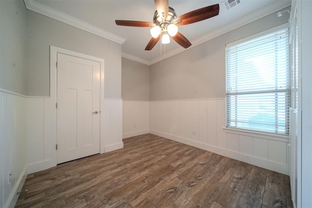 unfurnished room featuring a wealth of natural light, crown molding, ceiling fan, and dark hardwood / wood-style floors