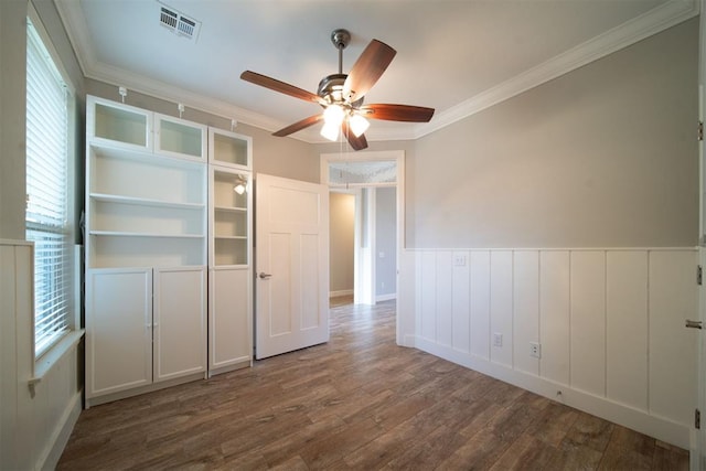 unfurnished bedroom featuring hardwood / wood-style floors, ceiling fan, and ornamental molding