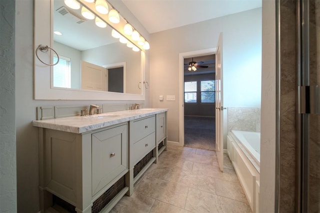 bathroom featuring vanity, ceiling fan, and tiled tub