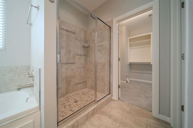 bathroom with tile patterned floors and plus walk in shower