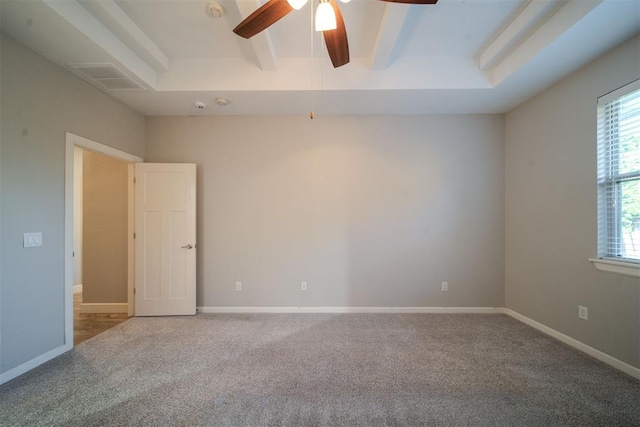 carpeted empty room with beam ceiling and ceiling fan