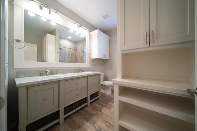 bathroom featuring hardwood / wood-style floors, vanity, and toilet