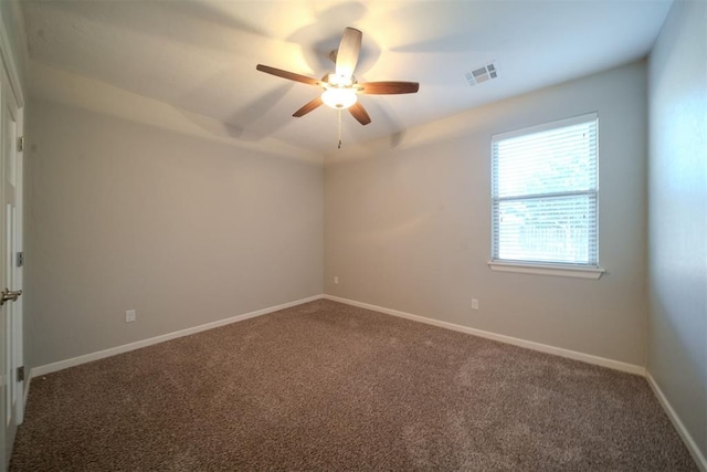 spare room featuring carpet and ceiling fan