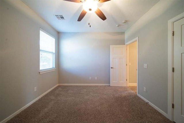 carpeted spare room with ceiling fan